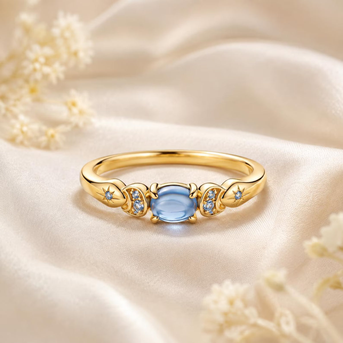 Jasmine-inspired ring with a blue center stone, crescent moons and stars