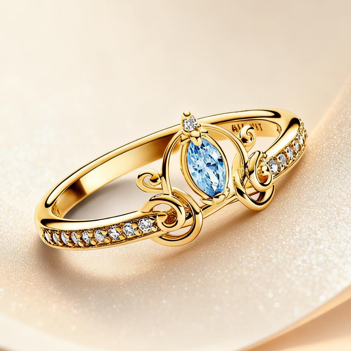 Gold-plated Cinderella carriage ring with a blue center stone